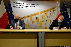 Pamiątkowe zdjęcie z konferencji dotyczącej podpisania umów w ramach kształcenia zawodowego Regionalnego Programu Operacyjnego Województwa Lubelskiego na lata 2014-2020. Na zdjęciu umowę podpisują od lewej: Marszałek Województwa Lubelskiego Jarosław Stawiarski oraz Starosta Powiatu Ryckiego Dariusz Szczygielski